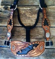 Hand tooled, inlaid and buckstitched bronc halter with fancy cheeks.