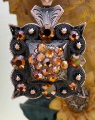 Bling Concho necklace.  Square bronze berry w/ Smoke Topaz and Copper Swarovskis on an 18" brown cord necklace.