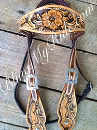 Hand tooled browband headstall with feathers and scroll work.