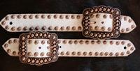 Belt style spur strap. White hair-on hide and Ant. Bronze fancy spots and Buckles.