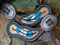 Hand tooled and painted feather spur straps.