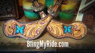 Hand tooled butterfly spur straps.