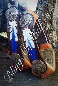 Hand tooled and painted feather stirrups with indian chief head conchos.