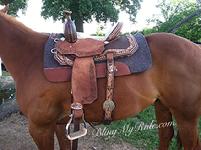 Hand tooled and buckstitched barrel saddle with Swarovskis and embossed croc. seat.